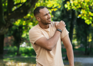 Man grasping shoulder in pain showing Performance Declines Before Testosterone
