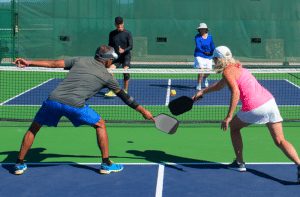 Pickleball players on court illustrating common pickleball injuries treated at Momentum Medical Central Florida